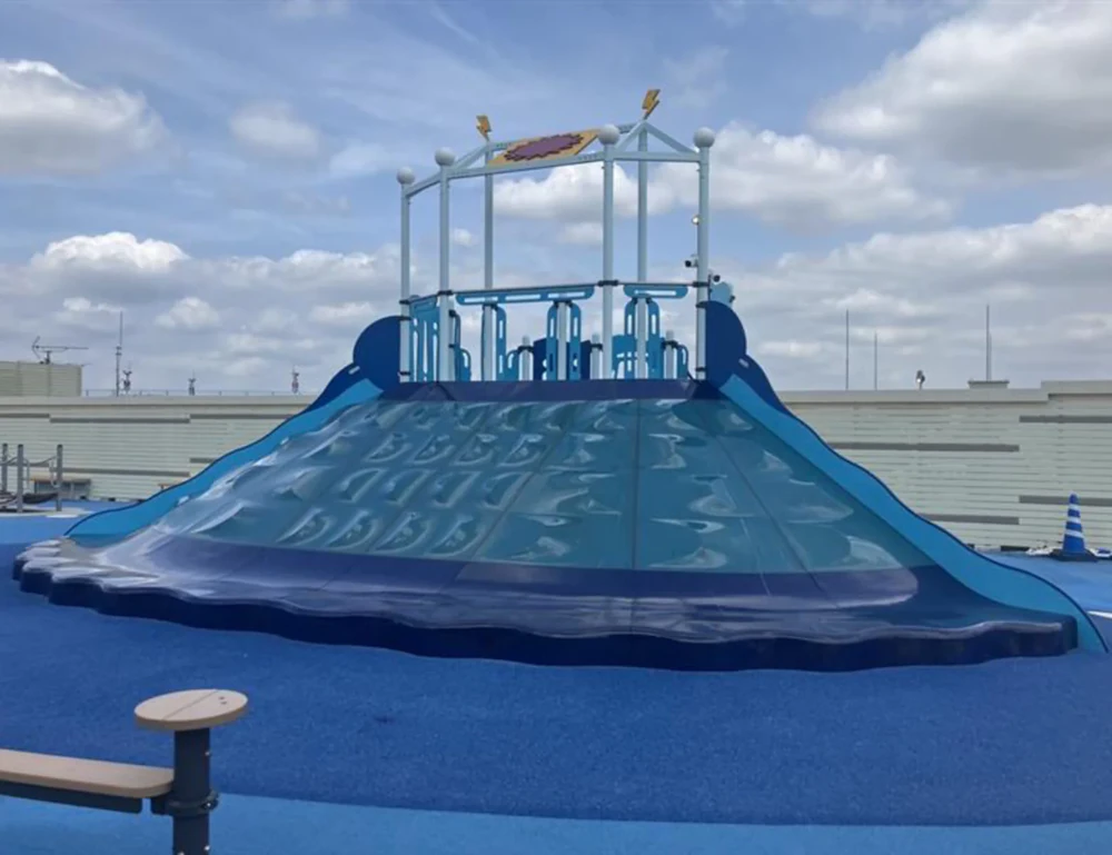 A large blue, mountain-shaped slide