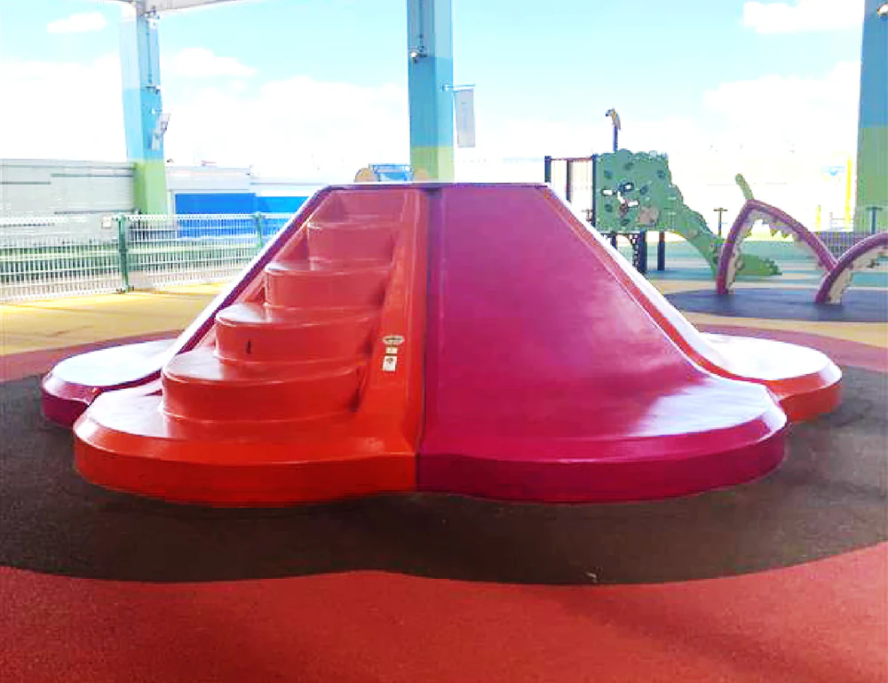 A red slide shaped like a flower
