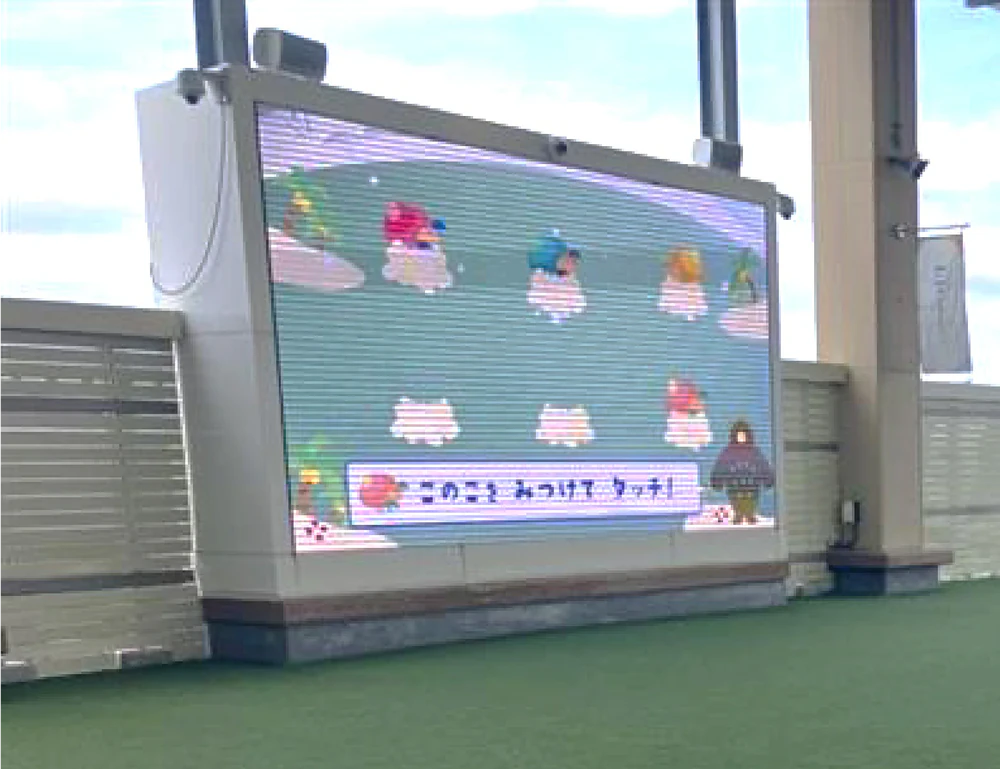 A picnic area where you can enjoy interactive games on large digital signage.