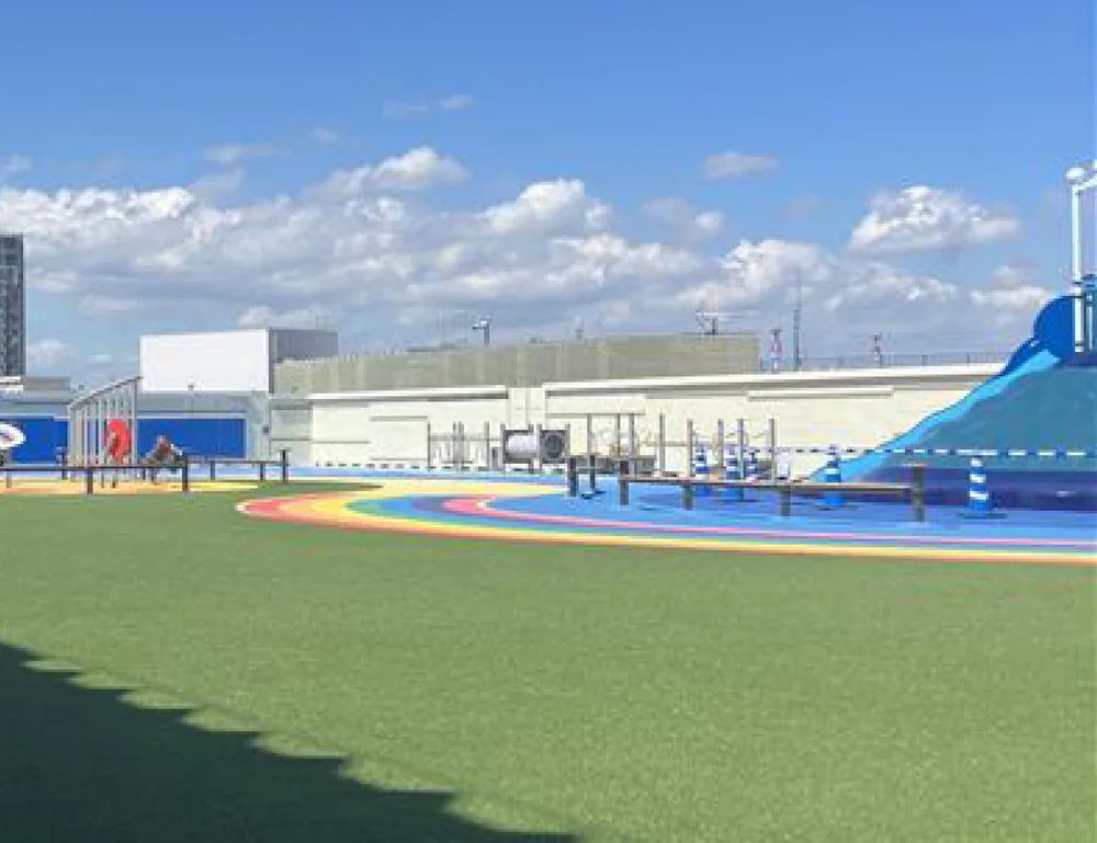 A picnic area with artificial turf under the blue sky.
