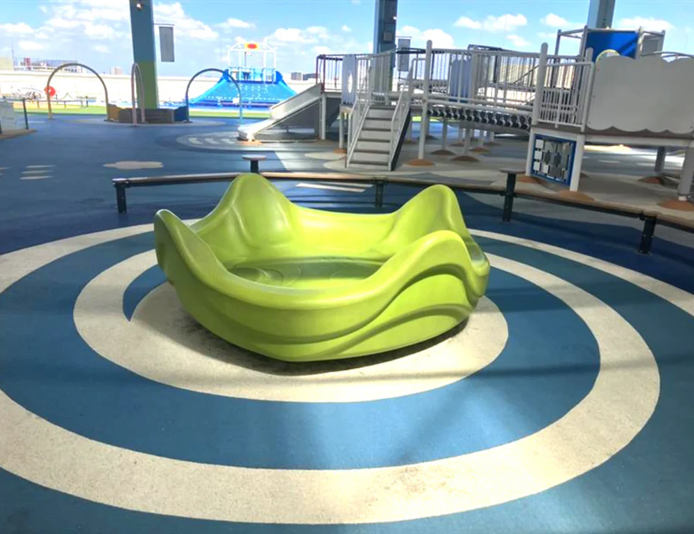 Green spinning playground equipment